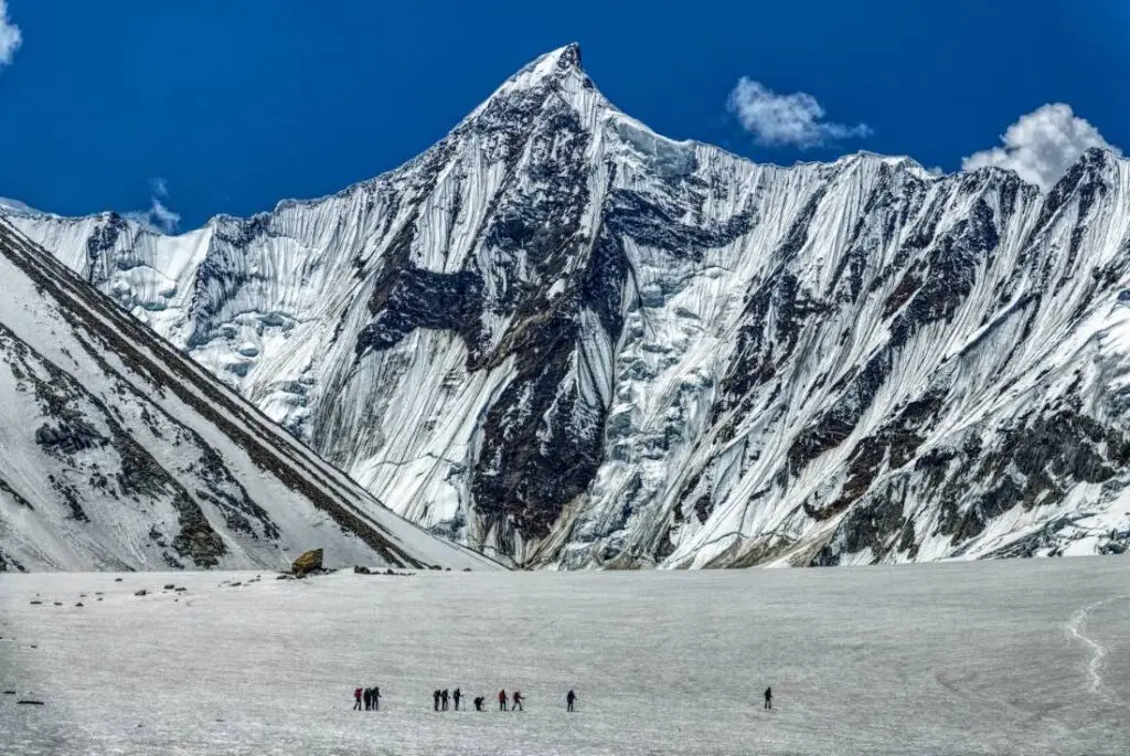 Baltoro Glacier trek itinerary view: turquoise meltwater pool between ice walls…