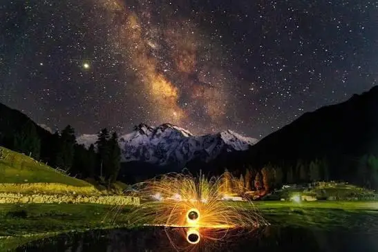 Nanga Parbat glowing orange at sunset seen from Fairy Meadows in Gilgit-Baltistan